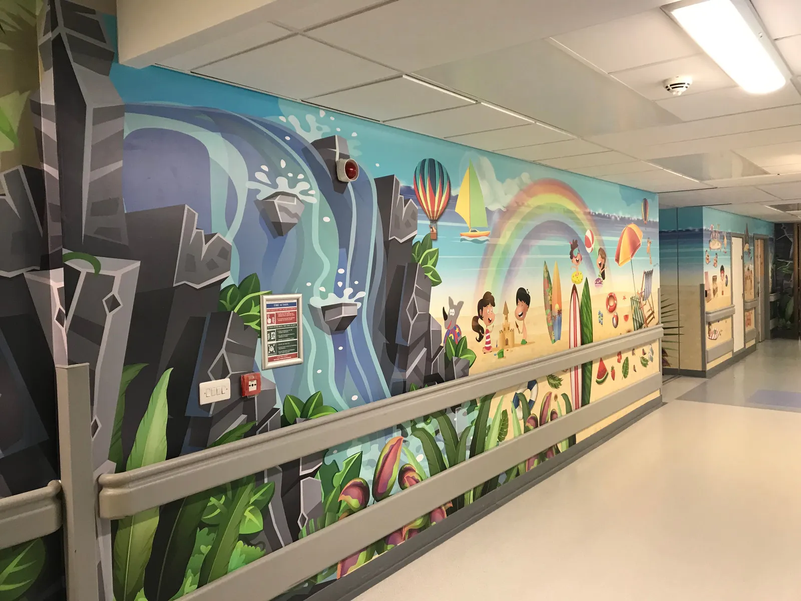 Rainbow and waterfall hospital corridor mural by It'z Print & Design